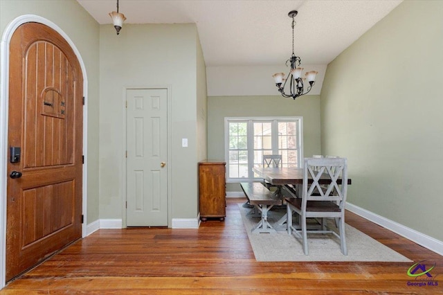 283 Limestone Rd, Cochran, GA 31014 - dining room with wood finished floors, a chandelier, and baseboards