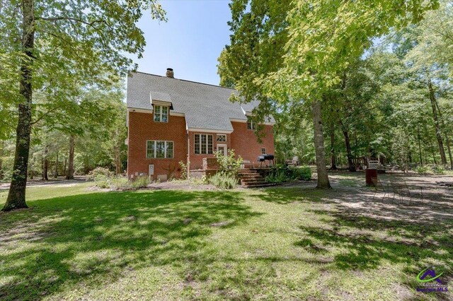 283 Limestone Rd, Cochran, GA 31014 - rear view of property with a lawn, brick siding, and a chimney