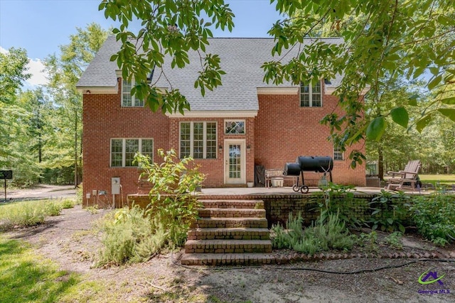 283 Limestone Rd, Cochran, GA 31014 - back of house with brick siding, a patio area, and a shingled roof