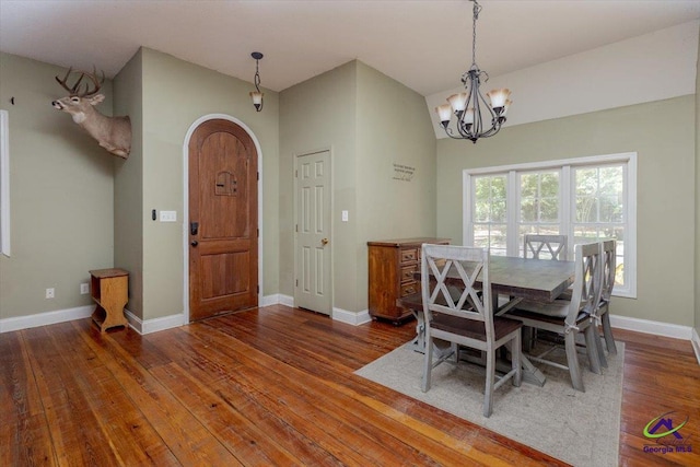 283 Limestone Rd, Cochran, GA 31014 - dining space with a chandelier, wood finished floors, baseboards, and arched walkways
