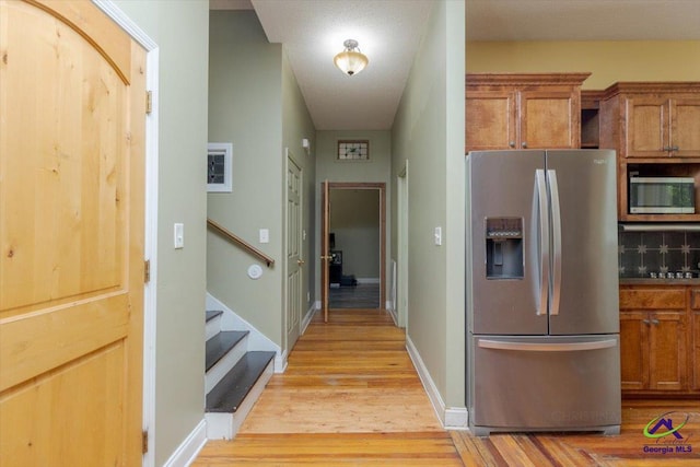 283 Limestone Rd, Cochran, GA 31014 - hall featuring light wood-style floors, stairway, and baseboards
