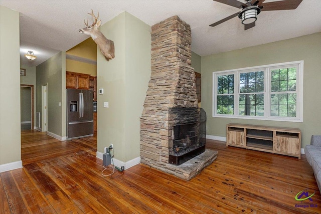 283 Limestone Rd, Cochran, GA 31014 - unfurnished living room with a ceiling fan, baseboards, hardwood / wood-style floors, a textured ceiling, and radiator