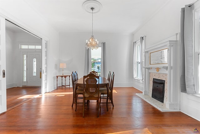 110 Minor Ave, Montezuma, GA 31063 - dining area with a chandelier, hardwood / wood-style flooring, crown molding, a high end fireplace, and baseboards