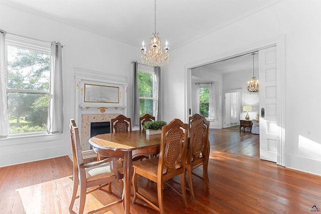 110 Minor Ave, Montezuma, GA 31063 - dining room featuring a chandelier, wood finished floors, ornamental molding, and a tiled fireplace