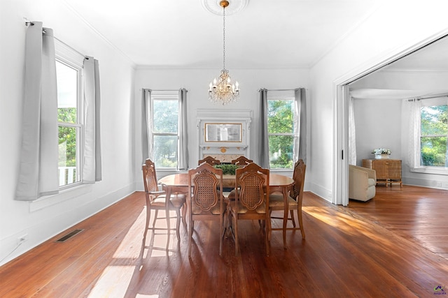110 Minor Ave, Montezuma, GA 31063 - dining space featuring a chandelier, hardwood / wood-style flooring, crown molding, and baseboards