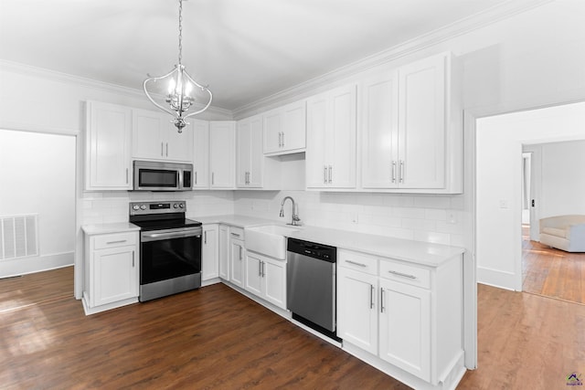 110 Minor Ave, Montezuma, GA 31063 - kitchen featuring appliances with stainless steel finishes, light countertops, a sink, tasteful backsplash, and crown molding