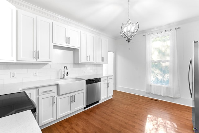 110 Minor Ave, Montezuma, GA 31063 - kitchen with appliances with stainless steel finishes, a sink, white cabinets, crown molding, and dark wood-type flooring