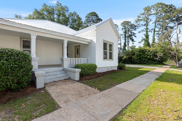 110 Minor Ave, Montezuma, GA 31063 - view of front of property with a porch, a front yard, and metal roof