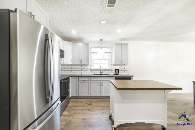 108 Marcia Ct, Warner Robins, GA 31088 - kitchen featuring freestanding refrigerator, a sink, butcher block counters, a textured ceiling, and electric range