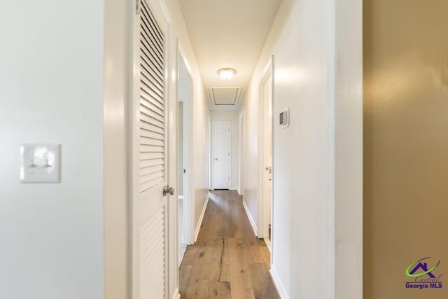 108 Marcia Ct, Warner Robins, GA 31088 - hall featuring attic access, light wood-style flooring, and baseboards