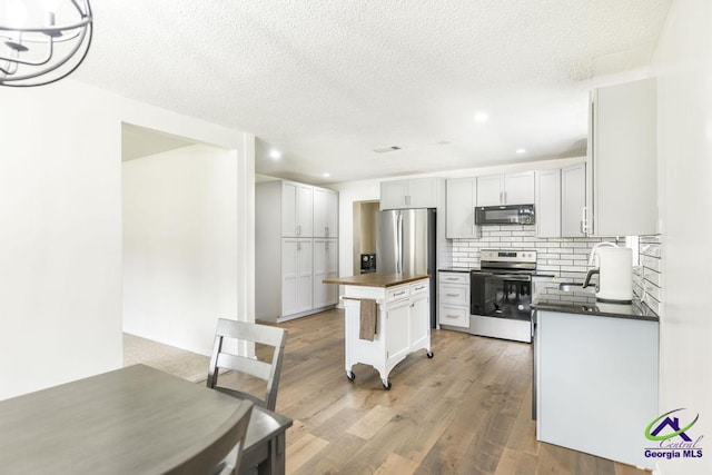 108 Marcia Ct, Warner Robins, GA 31088 - kitchen featuring stainless steel appliances, butcher block counters, decorative backsplash, light wood-style flooring, and recessed lighting