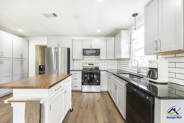 108 Marcia Ct, Warner Robins, GA 31088 - kitchen with black appliances, a sink, wooden counters, decorative backsplash, and wood finished floors