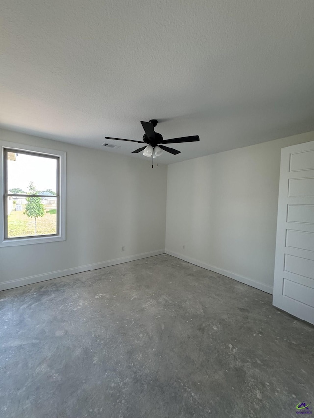 502 Otters Ridge Dr, Kathleen, GA 31047 - spare room featuring concrete flooring, ceiling fan, a textured ceiling, and baseboards