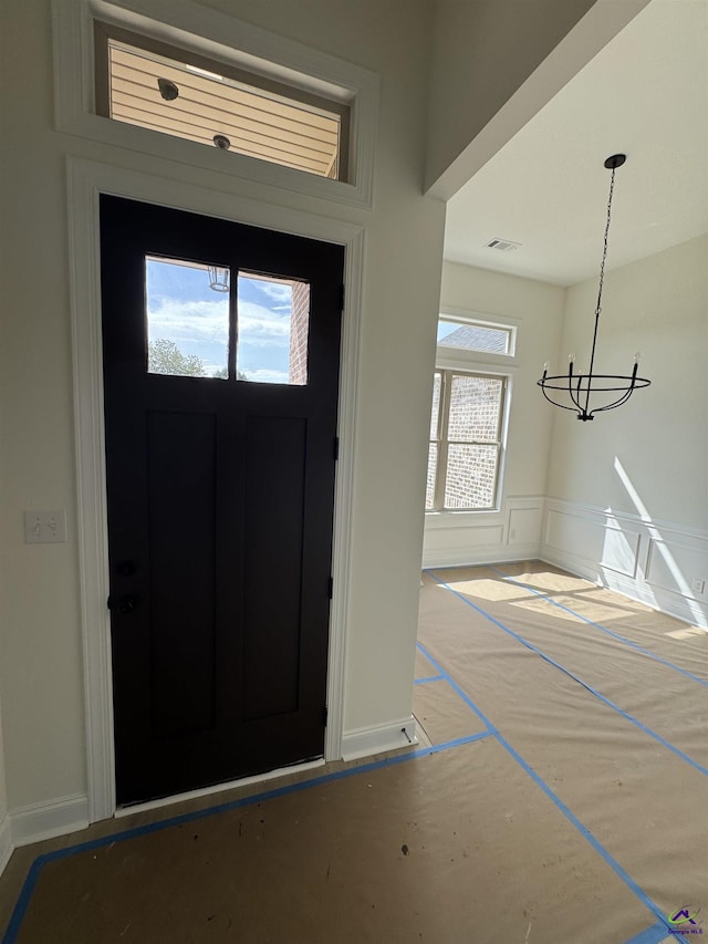 502 Otters Ridge Dr, Kathleen, GA 31047 - entrance foyer featuring a chandelier, a wainscoted wall, and a decorative wall