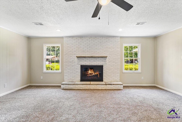 214 Markwood Dr, Warner Robins, GA 31093 - unfurnished living room with carpet, a brick fireplace, a textured ceiling, ceiling fan, and baseboards