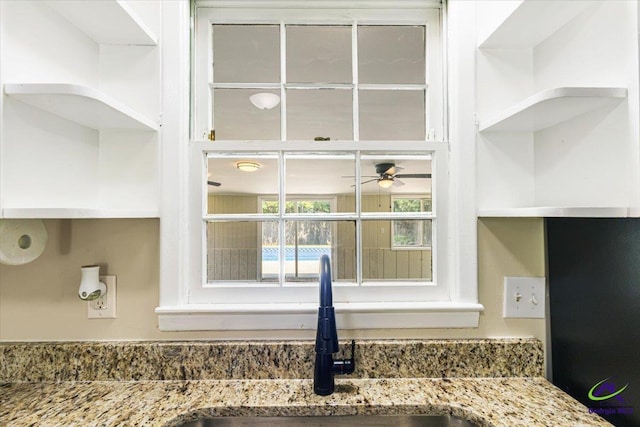 214 Markwood Dr, Warner Robins, GA 31093 - kitchen view of open shelves, a sink, stone countertops, and ceiling fan
