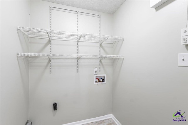 214 Markwood Dr, Warner Robins, GA 31093 - laundry area featuring washer hookup, baseboards, and a textured ceiling