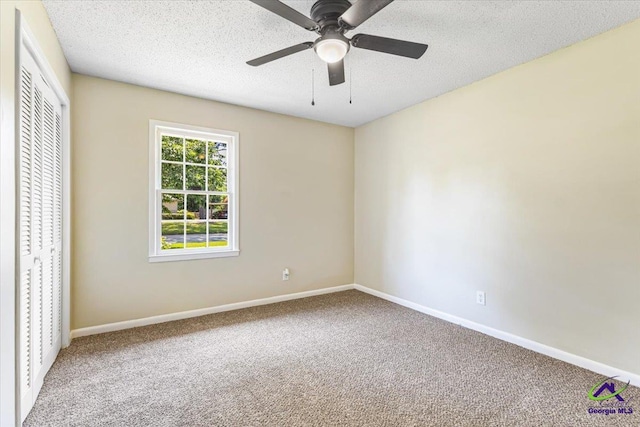 214 Markwood Dr, Warner Robins, GA 31093 - unfurnished bedroom featuring carpet flooring, baseboards, a closet, a textured ceiling, and ceiling fan