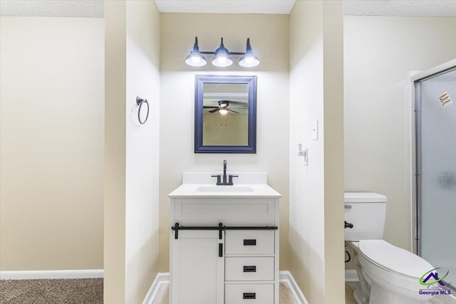 214 Markwood Dr, Warner Robins, GA 31093 - bathroom featuring vanity, toilet, a shower stall, a ceiling fan, and baseboards