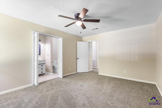 214 Markwood Dr, Warner Robins, GA 31093 - unfurnished bedroom featuring carpet floors, baseboards, a textured ceiling, ensuite bath, and ceiling fan