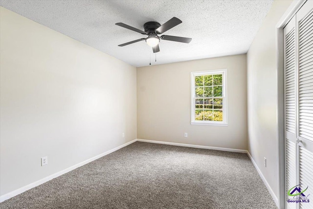 214 Markwood Dr, Warner Robins, GA 31093 - unfurnished bedroom with carpet, a textured ceiling, a closet, baseboards, and a ceiling fan