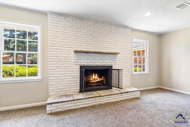 214 Markwood Dr, Warner Robins, GA 31093 - detailed view of carpet flooring, a brick fireplace, a textured ceiling, baseboards, and crown molding