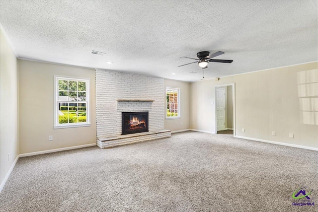 214 Markwood Dr, Warner Robins, GA 31093 - unfurnished living room with a ceiling fan, a textured ceiling, carpet floors, a brick fireplace, and baseboards