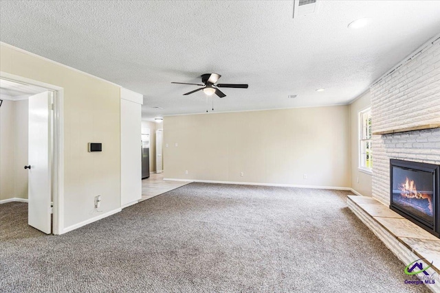 214 Markwood Dr, Warner Robins, GA 31093 - unfurnished living room featuring ceiling fan, carpet, a brick fireplace, a textured ceiling, and baseboards