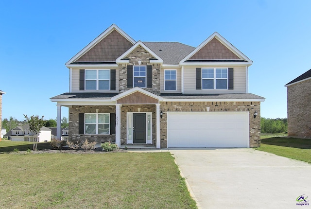 606 Samantha Brooke Way, Bonaire, GA 31005 - craftsman house with a front lawn, concrete driveway, an attached garage, and brick siding