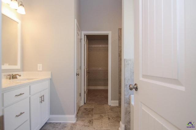 606 Samantha Brooke Way, Bonaire, GA 31005 - full bath with vanity, a walk in closet, and baseboards