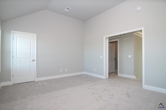 606 Samantha Brooke Way, Bonaire, GA 31005 - unfurnished bedroom with vaulted ceiling, light colored carpet, and baseboards