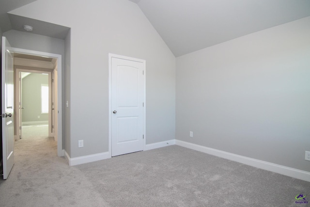 606 Samantha Brooke Way, Bonaire, GA 31005 - unfurnished bedroom with light carpet, lofted ceiling, and baseboards