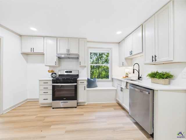 744 Corbin Ave, Macon, GA 31204 - kitchen featuring stainless steel appliances, under cabinet range hood, light countertops, light wood finished floors, and recessed lighting
