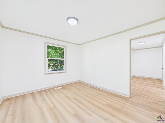 744 Corbin Ave, Macon, GA 31204 - unfurnished room with light wood-type flooring, baseboards, and crown molding