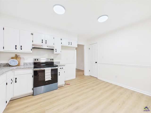 3081 Tiffin Cir, Macon, GA 31204 - kitchen with stainless steel range with electric stovetop, under cabinet range hood, light wood-style floors, white cabinets, and light stone counters