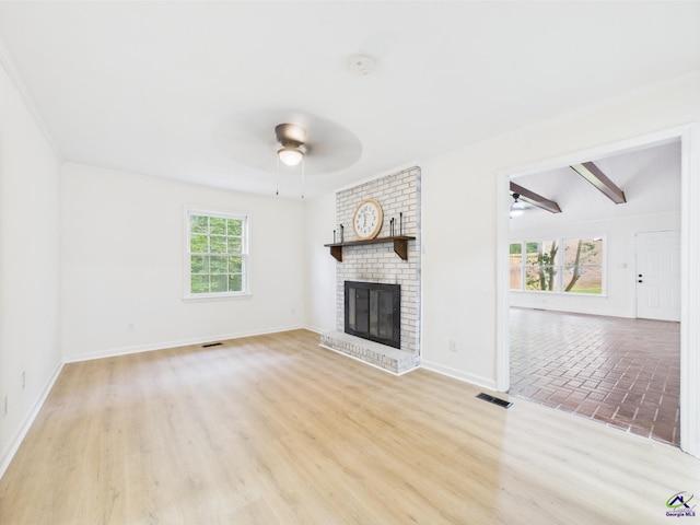 3081 Tiffin Cir, Macon, GA 31204 - unfurnished living room featuring a ceiling fan, a fireplace, baseboards, and light wood-type flooring