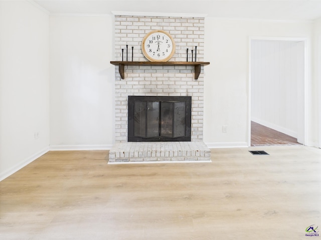 3081 Tiffin Cir, Macon, GA 31204 - unfurnished living room with wood finished floors, ornamental molding, a fireplace, and baseboards