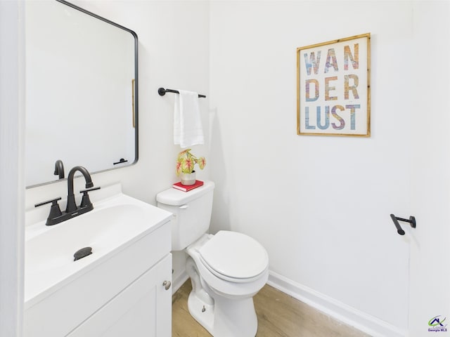 3081 Tiffin Cir, Macon, GA 31204 - half bath featuring vanity, baseboards, toilet, and wood finished floors