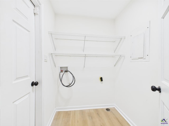 3081 Tiffin Cir, Macon, GA 31204 - washroom featuring light wood-type flooring, baseboards, hookup for a washing machine, and electric panel