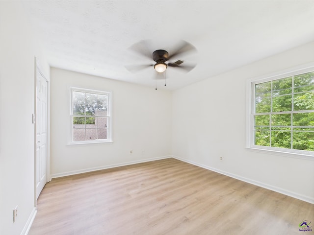 3081 Tiffin Cir, Macon, GA 31204 - empty room featuring light wood finished floors, healthy amount of natural light, a ceiling fan, and baseboards