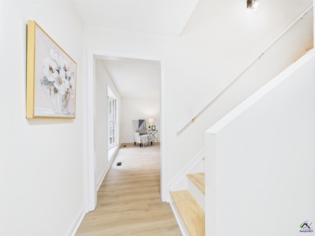 3081 Tiffin Cir, Macon, GA 31204 - hallway with light wood-style flooring, stairs, and baseboards