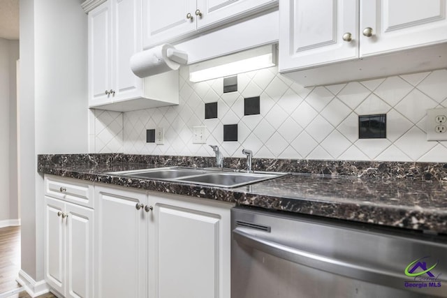 319 Smithville Church Rd, Warner Robins, GA 31088 - kitchen featuring stainless steel dishwasher, a sink, white cabinets, backsplash, and baseboards