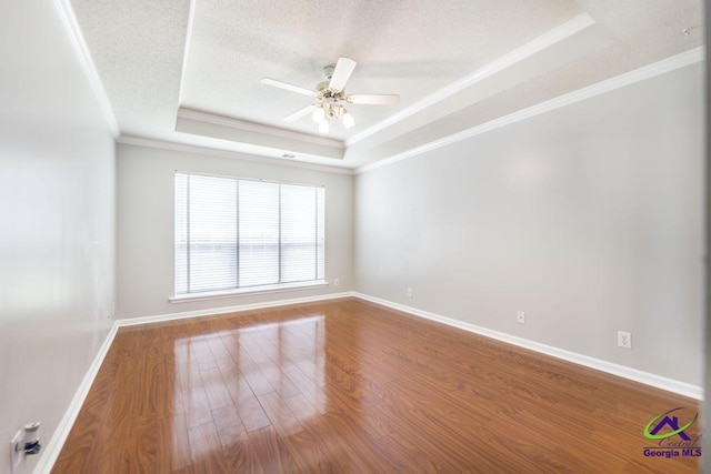 319 Smithville Church Rd, Warner Robins, GA 31088 - empty room with a tray ceiling, ornamental molding, a ceiling fan, a textured ceiling, and wood finished floors