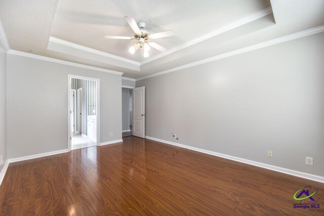 319 Smithville Church Rd, Warner Robins, GA 31088 - empty room featuring a tray ceiling, ceiling fan, wood finished floors, baseboards, and crown molding