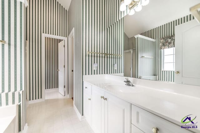 319 Smithville Church Rd, Warner Robins, GA 31088 - bathroom with wallpapered walls, vanity, baseboards, a stall shower, and a tub to relax in