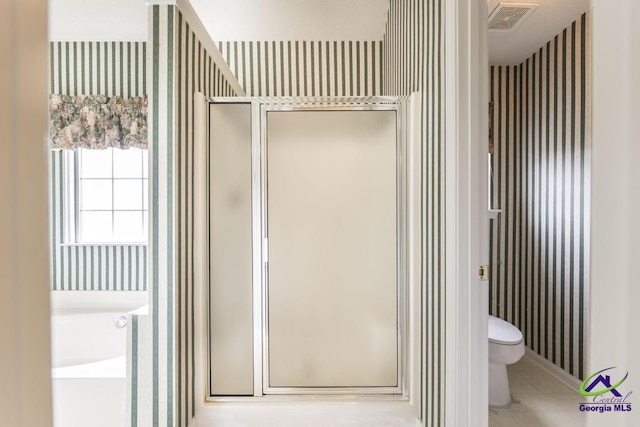 319 Smithville Church Rd, Warner Robins, GA 31088 - full bathroom featuring wallpapered walls, a shower stall, toilet, a bath, and tile patterned floors