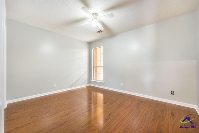 319 Smithville Church Rd, Warner Robins, GA 31088 - unfurnished room featuring ceiling fan, wood finished floors, a textured ceiling, and baseboards