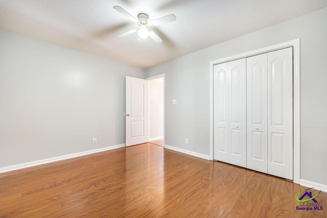 319 Smithville Church Rd, Warner Robins, GA 31088 - unfurnished bedroom featuring wood finished floors, baseboards, a closet, and a ceiling fan