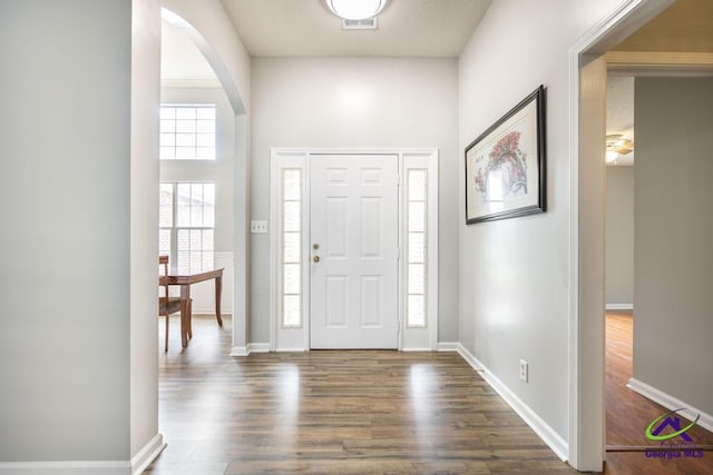 319 Smithville Church Rd, Warner Robins, GA 31088 - foyer entrance featuring dark wood-type flooring, arched walkways, and baseboards