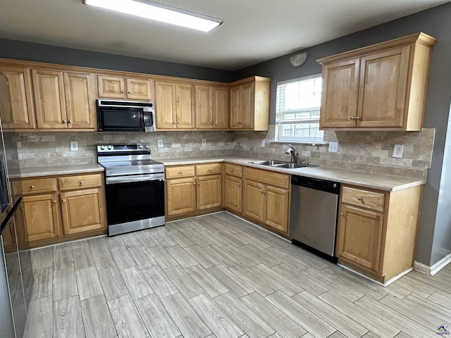 103 Lattice Bnd, Bonaire, GA 31005 - kitchen with appliances with stainless steel finishes, a sink, wood tiled floors, tasteful backsplash, and light countertops